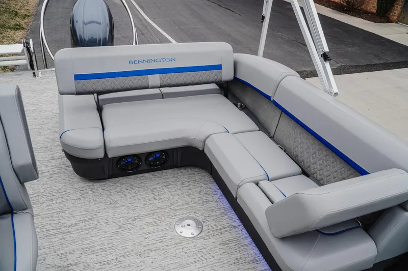 Slide: The Image of 2025 Bennington 24MSB boat interior with gray seating and blue accents. - 18