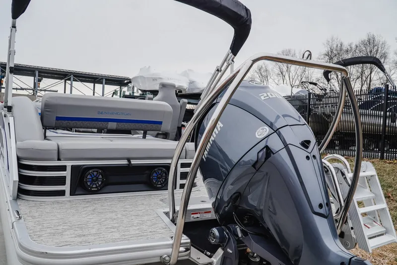 Slide: The Image of 2025 Bennington 24MSB pontoon boat with Yamaha outboard motor, docked outdoors. - 4