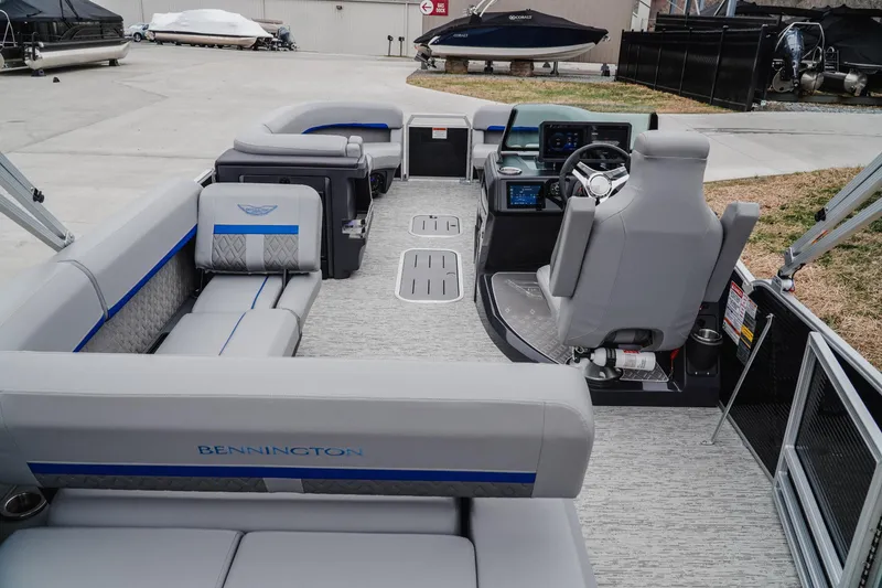 Slide: The Image of 2025 Bennington 24MSB pontoon boat interior with modern seating and helm controls. - 6