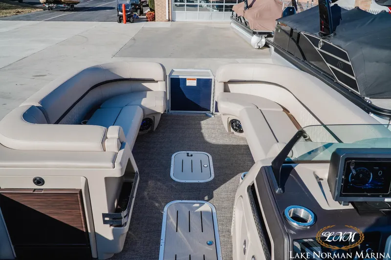 Slide: The Image of 2025 Bennington 24MSB pontoon boat interior with plush seating at Lake Norman Marina. - 11