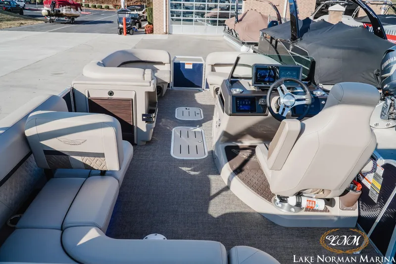 Slide: The Image of 2025 Bennington 24MSB pontoon boat interior with modern helm and spacious seating at Lake Norman Marina. - 7