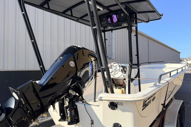 Slide: The Image of 2017 Carolina Skiff 258 DLV boat with Mercury outboard motor, parked outdoors. - 3