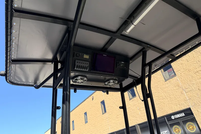 Slide: The Image of 2017 Carolina Skiff 258 DLV T-top with electronics and speakers, outdoor setting. - 4