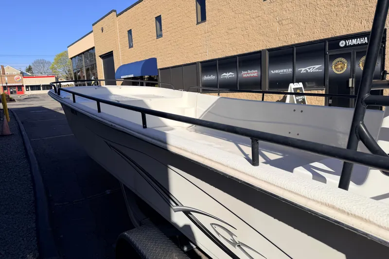 Slide: The Image of 2017 Carolina Skiff 258 DLV boat parked outside a marine dealership. - 8