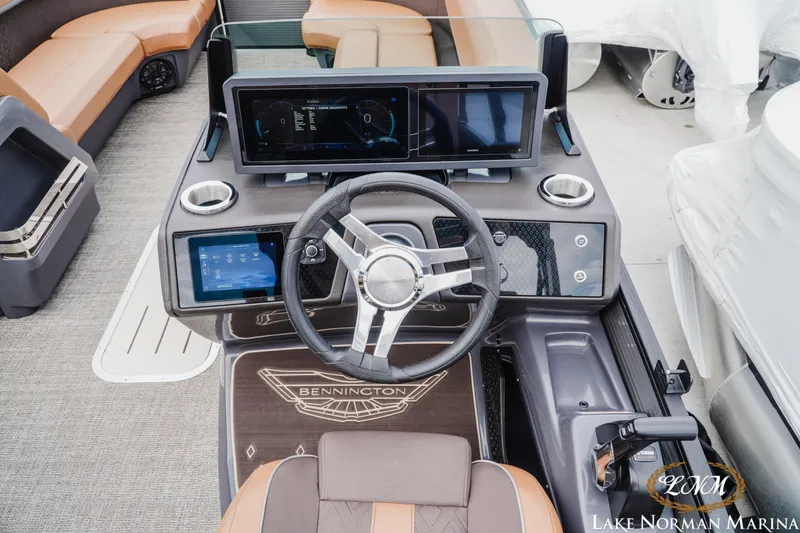 Slide: The Image of 2025 Bennington 24MSB boat dashboard with modern controls and steering wheel at Lake Norman Marina. - 10