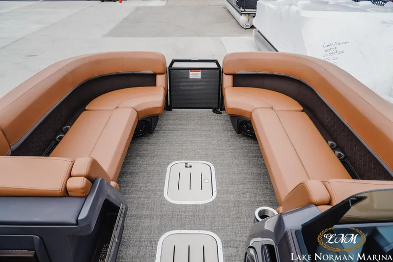 Slide: The Image of 2025 Bennington 24MSB pontoon boat with luxurious tan seating at Lake Norman Marina. - 11