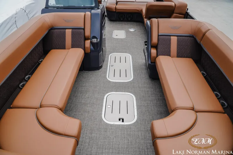 Slide: The Image of Luxurious interior of 2025 Bennington 24MSB pontoon boat with tan leather seating. - 14