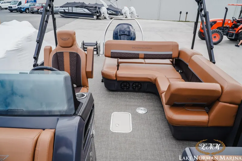 Slide: The Image of 2025 Bennington 24MSB boat interior with luxurious brown seating at Lake Norman Marina. - 17