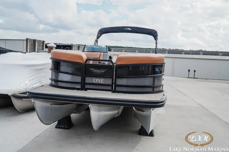 Slide: The Image of 2025 Bennington 24MSB pontoon boat at Lake Norman Marina, featuring sleek design and comfortable seating. - 5