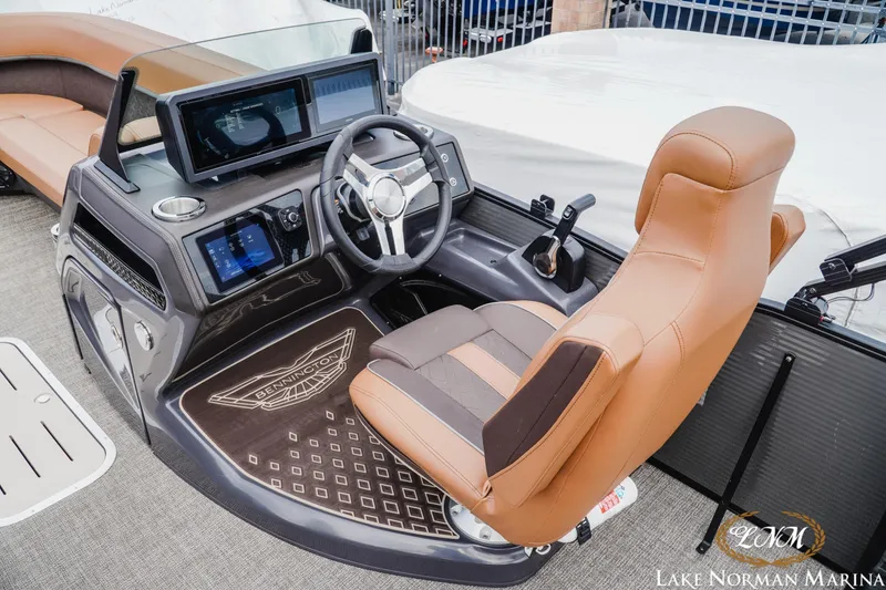 Slide: The Image of 2025 Bennington 24MSB boat helm with modern controls and luxurious captain's chair. - 9