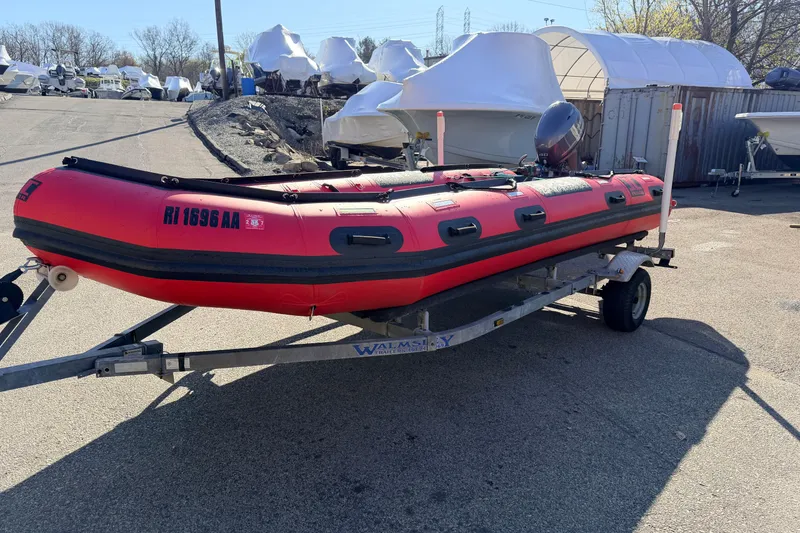 Slide: The Image of Red 2025 Inmar 530RHD inflatable boat on trailer in a boatyard. - 4