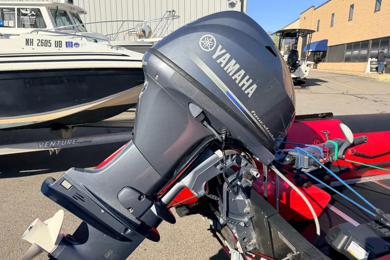 Slide: The Image of Yamaha outboard motor on 2025 Inmar 530RHD boat, parked outdoors. - 5