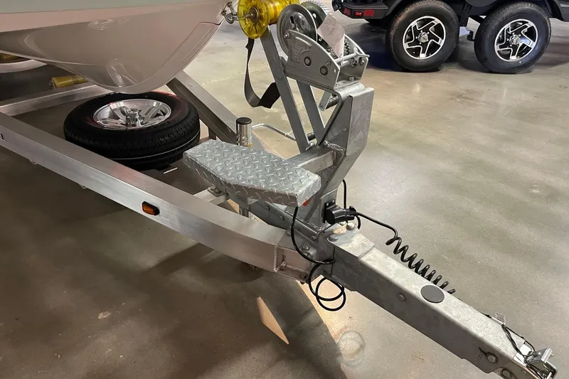 Slide: The Image of Trailer hitch of 2026 Ranger 2360 Bay boat with spare tire and safety cables. - 12