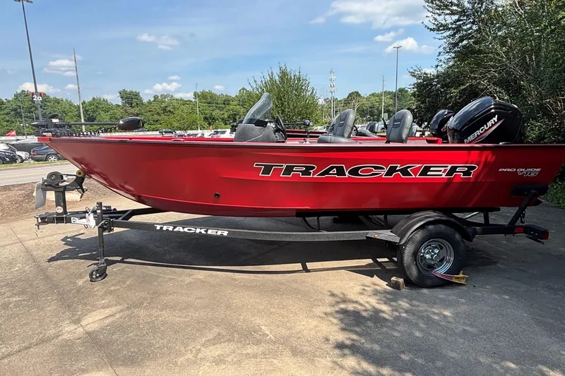 The Image of 2026 Tracker Pro Guide V-16 SC boat in vibrant red on a trailer. - 0