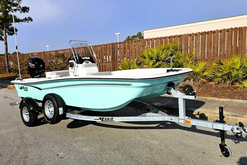 Slide: The Image of 2026 Mako Pro Skiff 15 CC boat on trailer, parked outdoors. - 5
