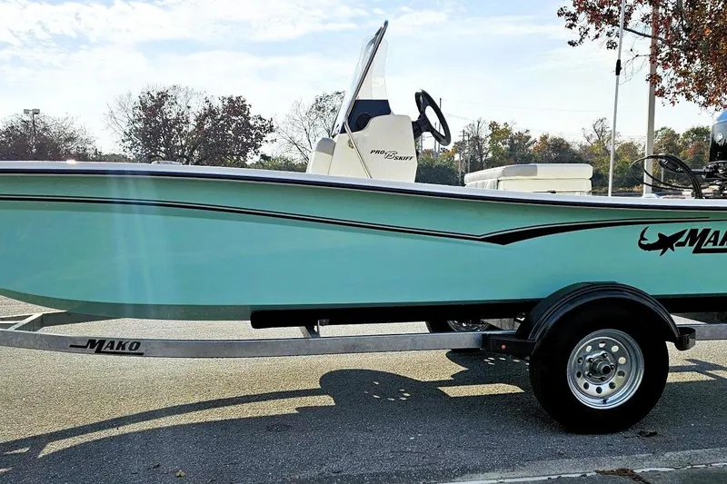 Slide: The Image of 2026 Mako Pro Skiff 15 CC boat on trailer, side view, outdoors. - 6