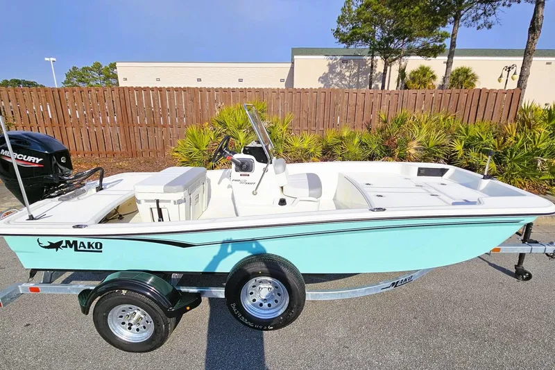 Slide: The Image of 2026 Mako Pro Skiff 15 CC boat on trailer, featuring a sleek design and Mercury engine. - 4