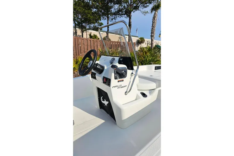 Slide: The Image of 2026 Mako Pro Skiff 15 CC boat console with steering wheel and controls. - 8