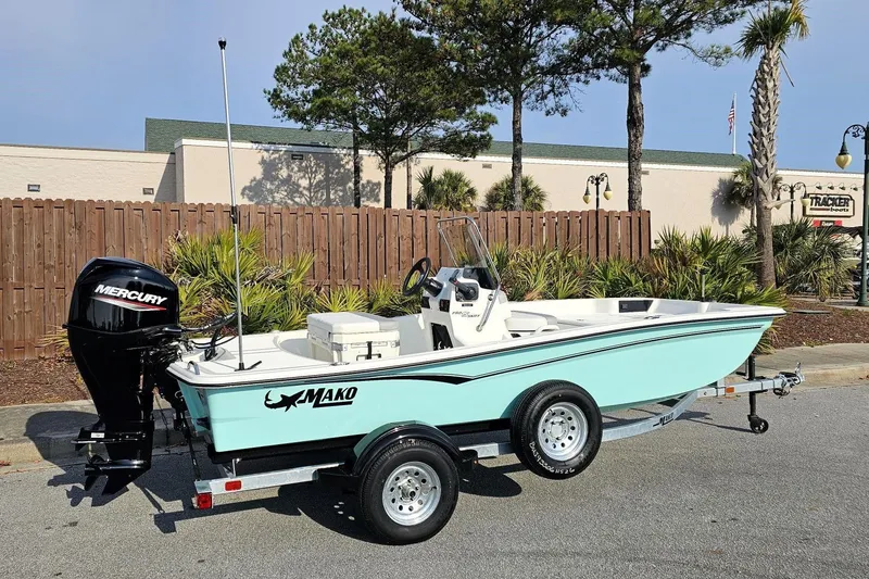 Slide: The Image of 2026 Mako Pro Skiff 15 CC boat on trailer with Mercury outboard motor. - 1