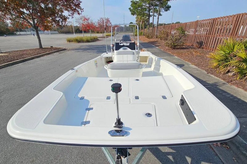 Slide: The Image of 2026 Mako Pro Skiff 15 CC boat in a parking lot, showcasing spacious deck design. - 9