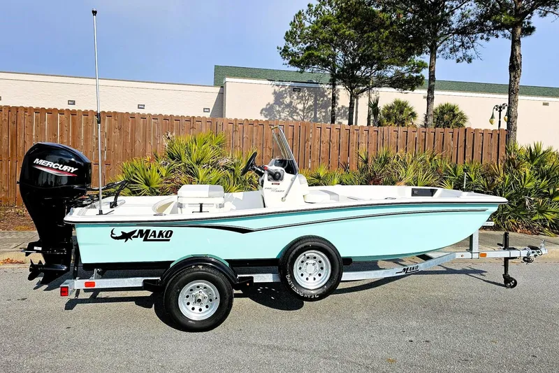 The Image of 2026 Mako Pro Skiff 15 CC boat on trailer, featuring a sleek design and Mercury engine. - 0