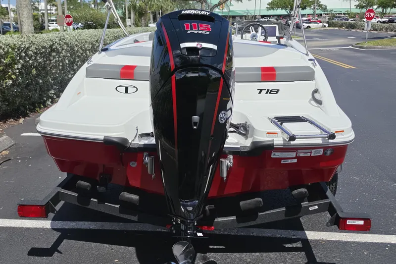 Slide: The Image of 2026 Tahoe T18 boat with Mercury 115 engine, parked on a trailer in a sunny lot. - 12