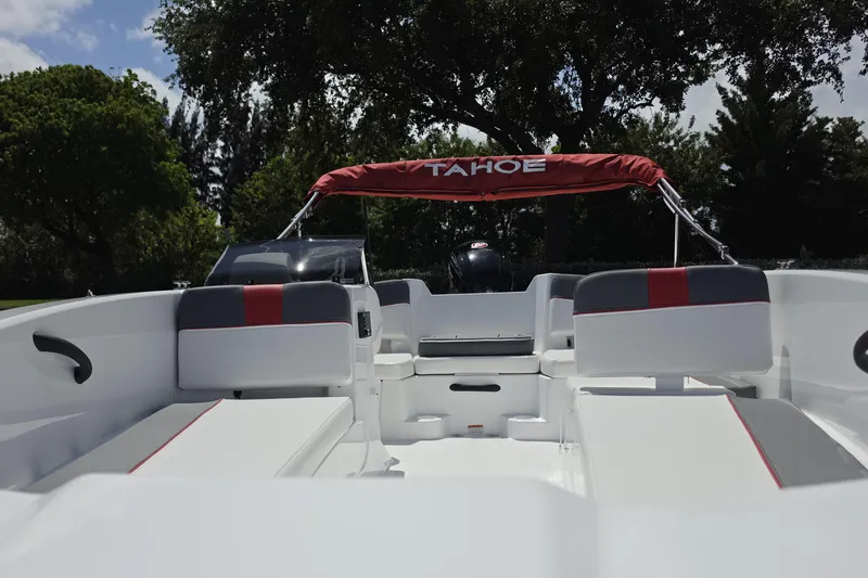 Slide: The Image of 2026 Tahoe T18 boat interior with white and red seating, under a sunny sky. - 8