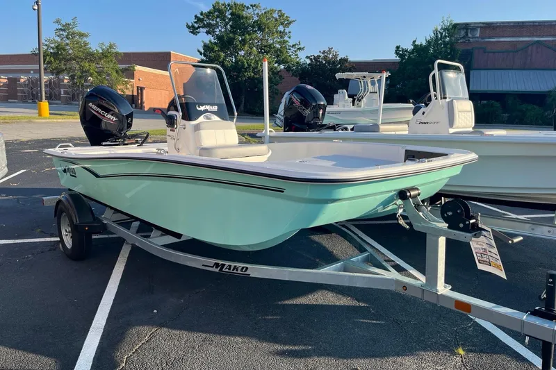 The Image of 2026 Mako Pro Skiff 15 CC boat on trailer in parking lot. - 0