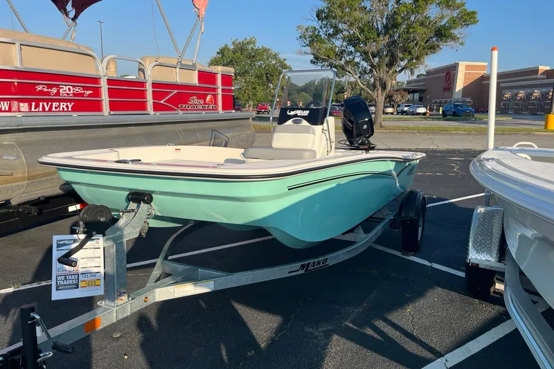 Slide: The Image of 2026 Mako Pro Skiff 15 CC boat on trailer in parking lot. - 1