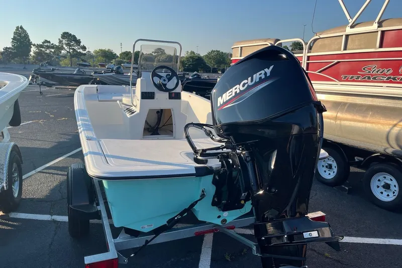 Slide: The Image of 2026 Mako Pro Skiff 15 CC with Mercury outboard motor in parking lot. - 7
