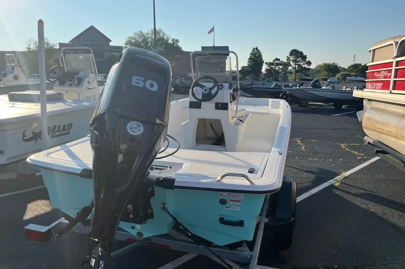 Slide: The Image of 2026 Mako Pro Skiff 15 CC boat with Mercury 60 engine in parking lot. - 6