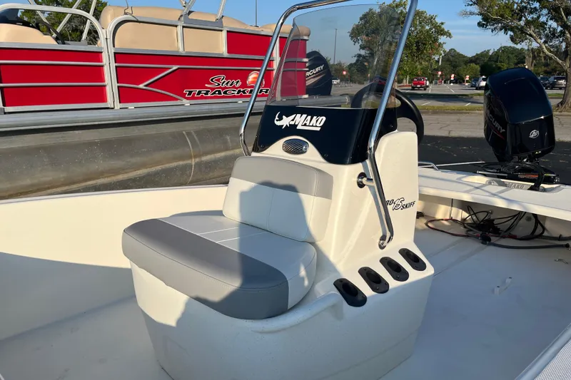 Slide: The Image of 2026 Mako Pro Skiff 15 CC boat interior with seating and steering console. - 3