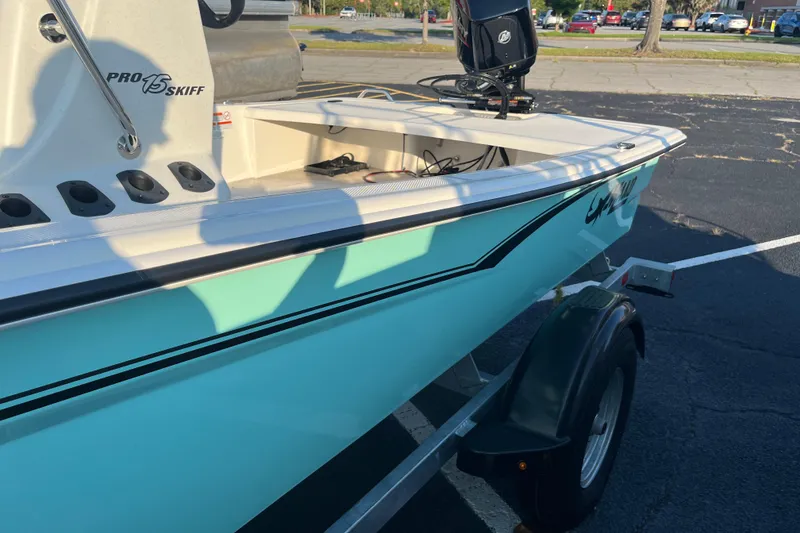 Slide: The Image of 2026 Mako Pro Skiff 15 CC boat on trailer in parking lot. - 5
