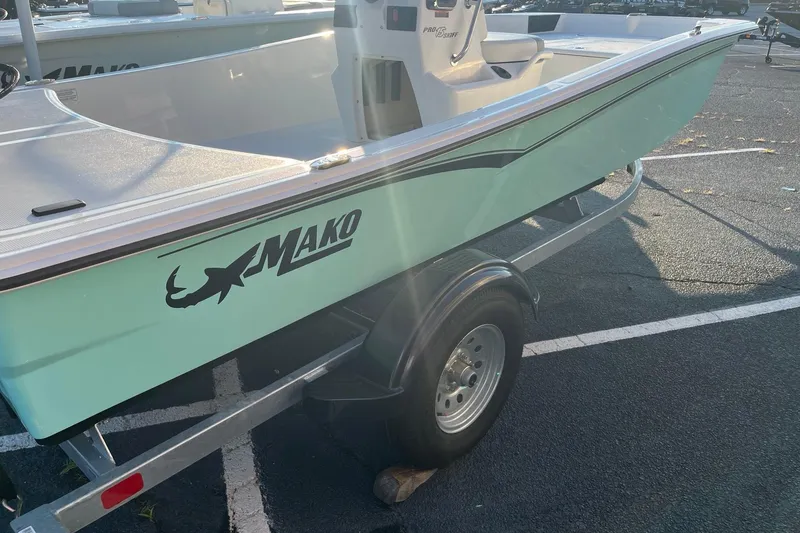 Slide: The Image of 2026 Mako Pro Skiff 15 CC boat on trailer in parking lot. - 4