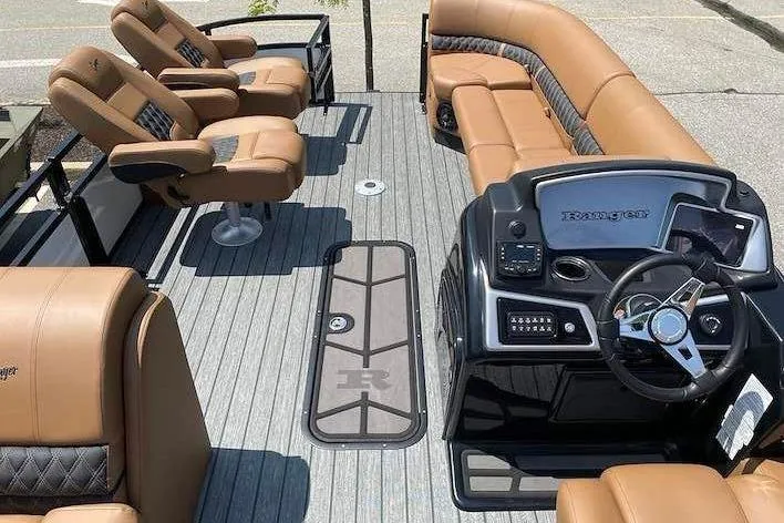 Slide: The Image of The image shows the interior of a Ranger 223FC boat with beige leather seats and a modern helm. - 8