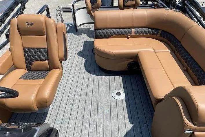Slide: The Image of The image shows the interior of a 2026 Ranger 223FC boat with brown leather seating. - 9