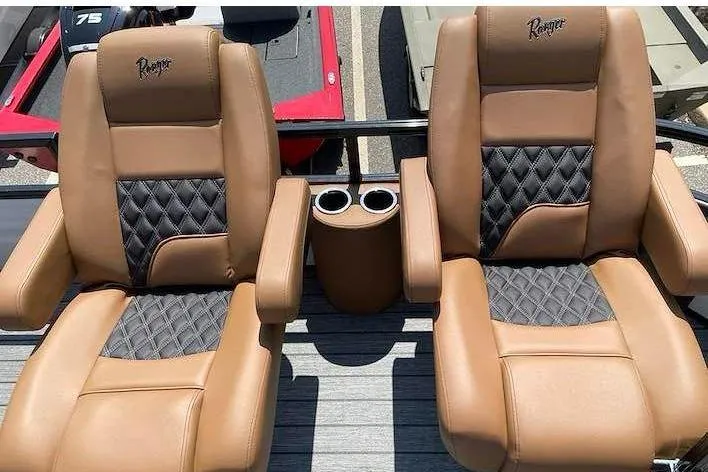 Slide: The Image of Two luxurious, padded boat seats in brown and black with cup holders in between. - 10
