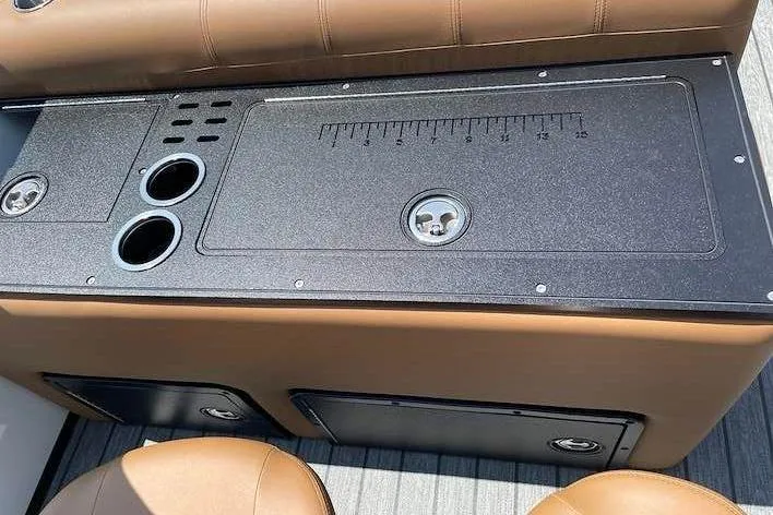 Slide: The Image of The image shows a boat console with cup holders and a ruler on the surface. - 12
