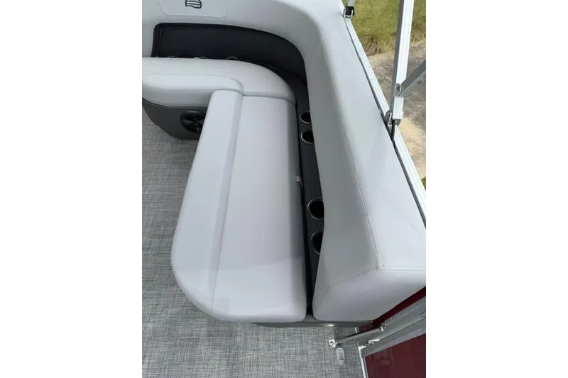 Slide: The Image of 2026 Sun Tracker Party Barge 16 DLX seating area with cup holders and gray upholstery. - 11