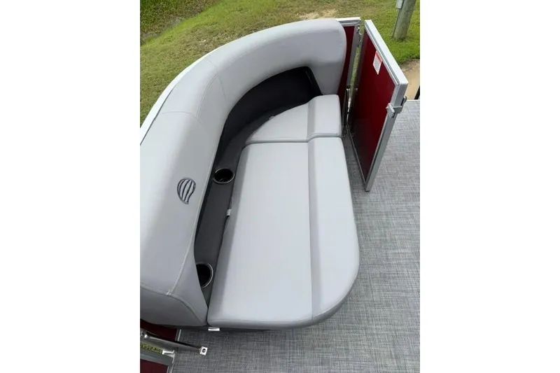 Slide: The Image of 2026 Sun Tracker Party Barge 16 DLX seating area with gray upholstery and cup holders. - 13