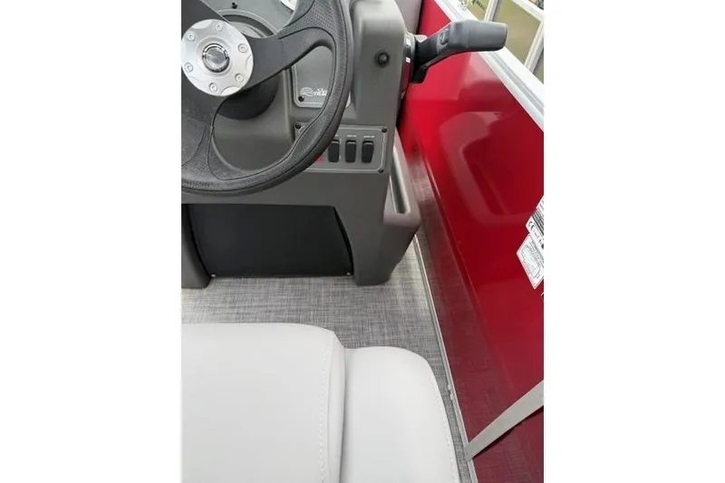 Slide: The Image of Interior view of 2026 Sun Tracker Party Barge 16 DLX with steering wheel and controls. - 7