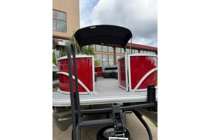 Slide: The Image of 2026 Sun Tracker Party Barge 16 DLX pontoon boat with red exterior and canopy. - 4