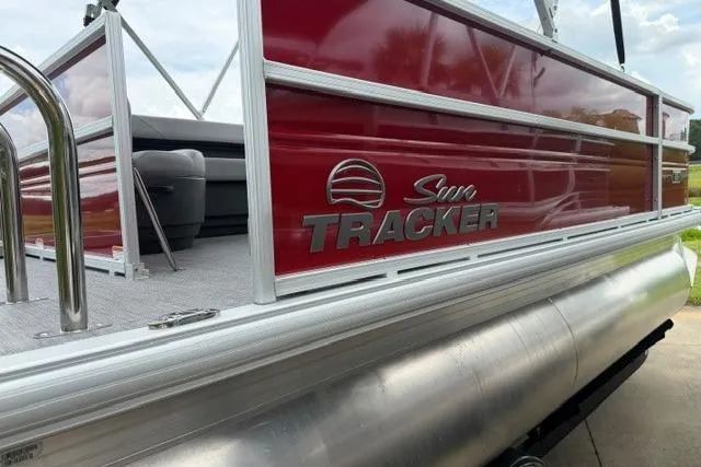 Slide: The Image of 2026 Sun Tracker Party Barge 16 DLX pontoon boat with red exterior and silver accents. - 2