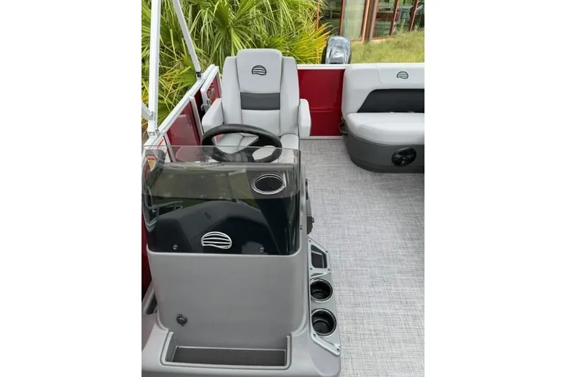 Slide: The Image of 2026 Sun Tracker Party Barge 16 DLX interior with steering console and seating. - 5