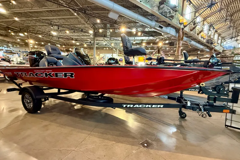 The Image of 2026 Tracker Pro Team 175 boat in showroom, vibrant red color, on trailer. - 0
