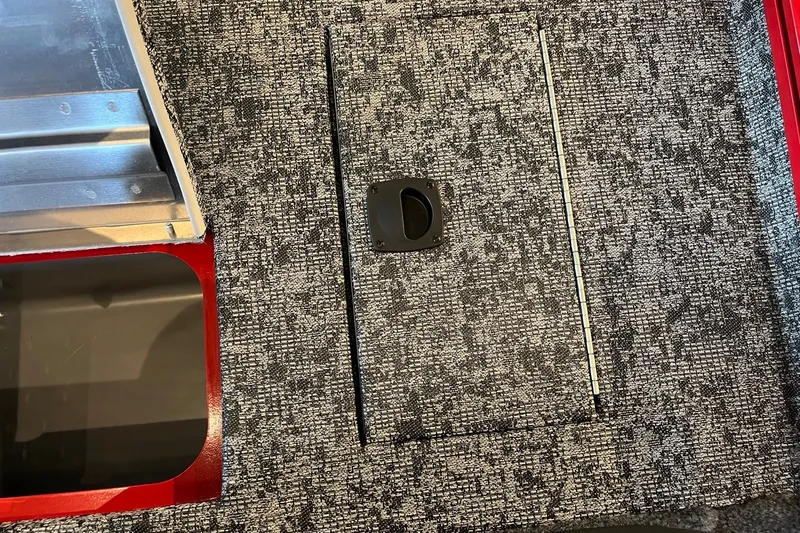 Slide: The Image of Carpeted deck of 2026 Tracker Pro Team 175 boat with storage compartment. - 17