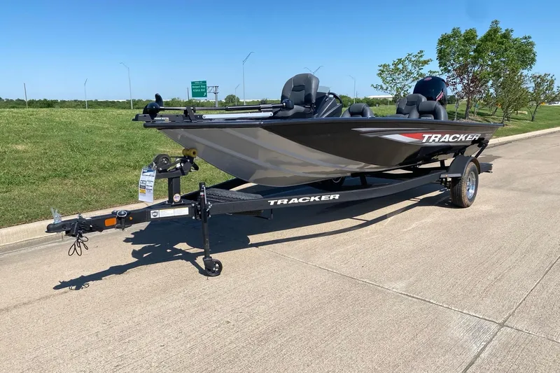 Slide: The Image of 2026 Tracker Pro Team 195 boat on trailer, parked on a sunny road. - 5