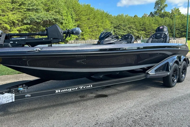 Slide: The Image of 2026 Ranger Z520R Cup-Equipped boat on trailer, parked outdoors with lush greenery background. - 1