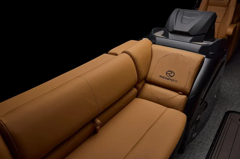 Slide: The Image of Interior of 2026 Regency 230 DL boat with tan leather seats and gray carpet flooring. - 17