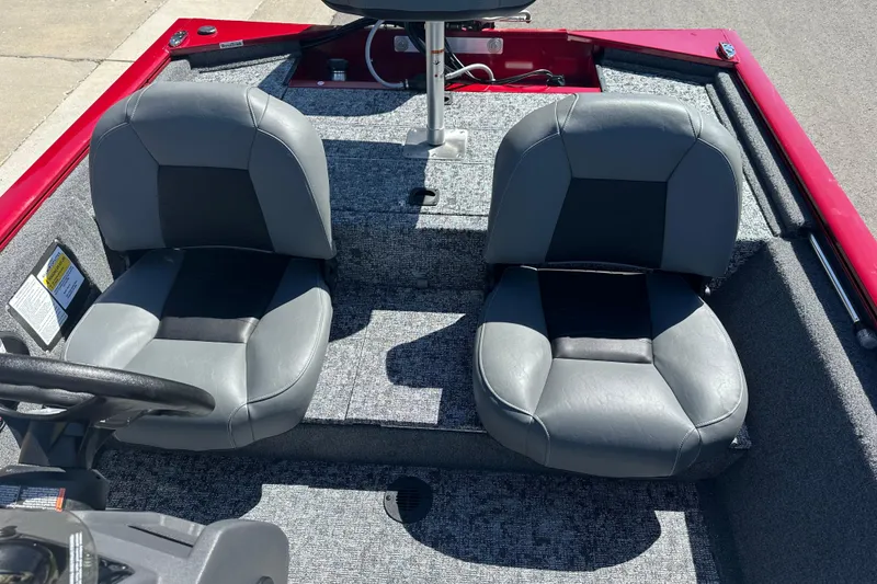 Slide: The Image of 2026 Tracker Pro 170 boat interior with two gray seats and red trim. - 14